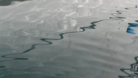 Reflection of the sea creates a curvy shape and sees a sailor's rope.
