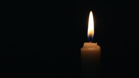 lit candle - black background
