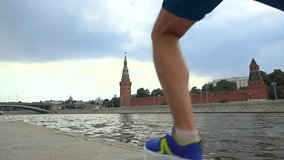 Athletic man running against Moscow Kremlin. Super slow motion steadicam video 240 fps