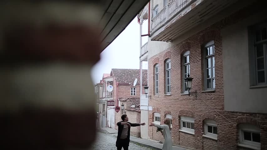 Couple hugging on the old street view from the corner.