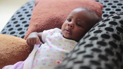 Thalia African Cute baby girl cries as mum picks her up