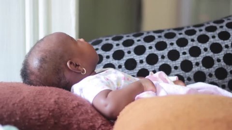 Black African 3 Month Old Baby Girl Lying looking up