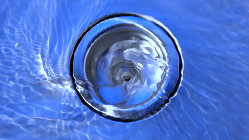 Water swirls down a sink drain