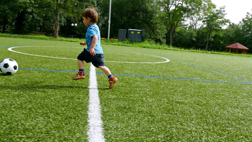 Tracking camera of a little boy scoring a goal in football field Royalty-Free Stock Footage #17779228