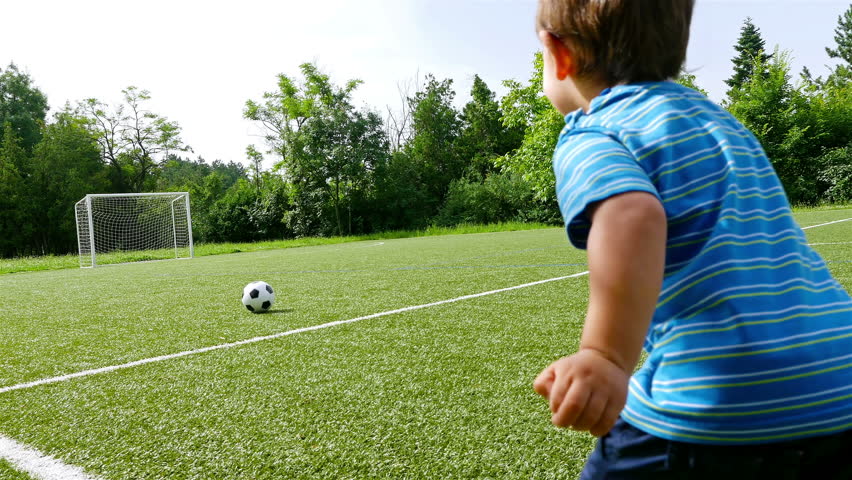 Tracking camera of a little boy scoring a goal in football field Royalty-Free Stock Footage #17779231