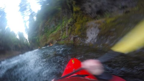 POV of man kayaking Takilma gorge section of the Rogue River in Southern Oregon
