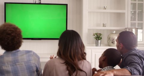 Rear View Of Family Watching Green Screen TV Shot On R3D