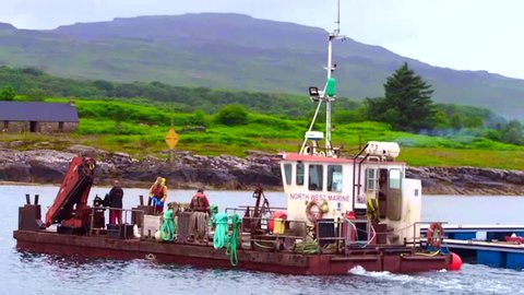 June 29th 2016. Ulva, Isle of Mull, Scotland, UK. Workmen working on the new floating platoon at the Vulva ferry, Isle of Mull, Scotland, Uk