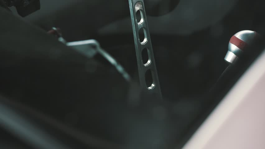 Drift Car Interior. Rack focus, close up on wheel and gearshift clutch