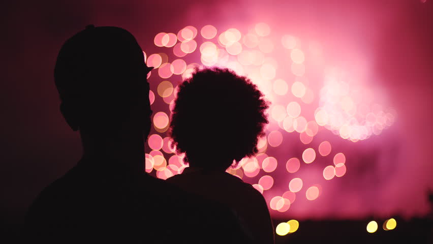 Unrecognizable family father and child watching fireworks