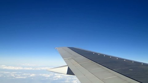 White clouds under aircraft wing