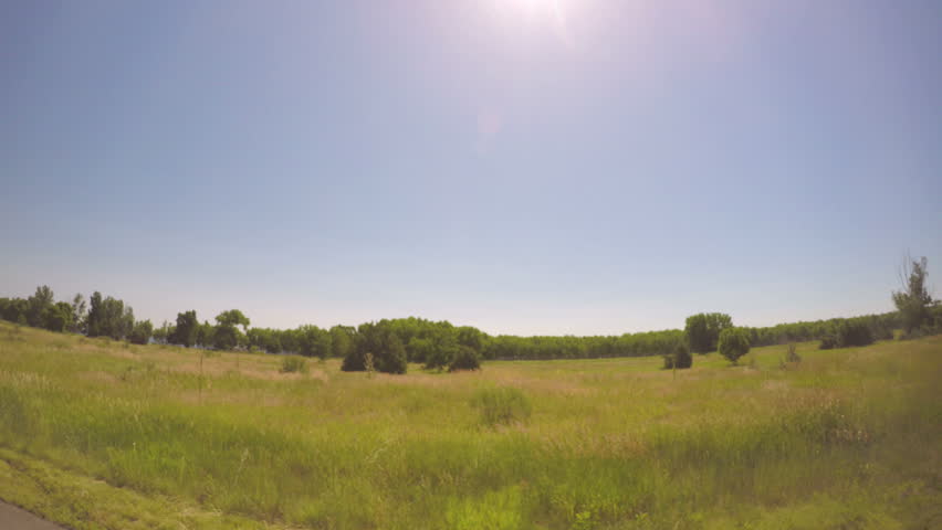Car driving through grassland at Chatfield State Park.-POV point of view.