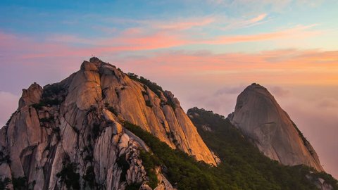 Time lapse of Bukhansan mountains is covered by morning fog and sunrise in Seoul,Korea.