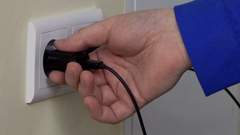 hand pull out charger adapter into wall socket.