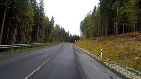 Driving on a mountain rural road. Point of view camera filming.