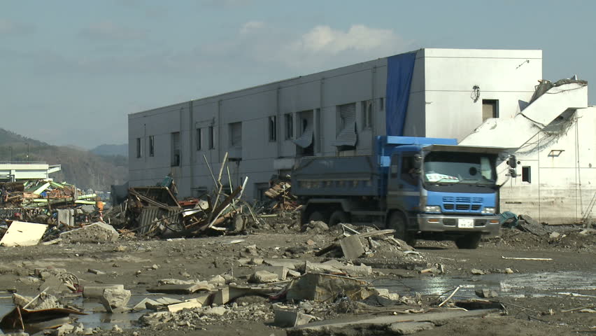 Truck drives through tsunami devastated port area in Kesennuma, Japan circa