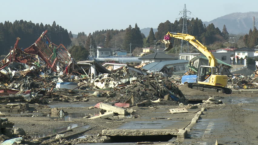 Heavy machinery moves through tsunami stricken town of Kesennuma, Japan circa