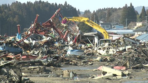 Heavy machinery moves through tsunami stricken town of Kesennuma, Japan circa April 2011.