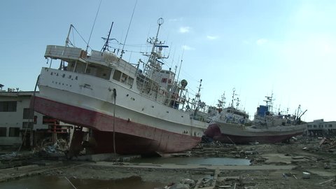 KESENNUMA, JAPAN - CIRCA APRIL 2011: Ships rest inland in tsunami stricken port in Kesennuma, Japan circa April 2011.