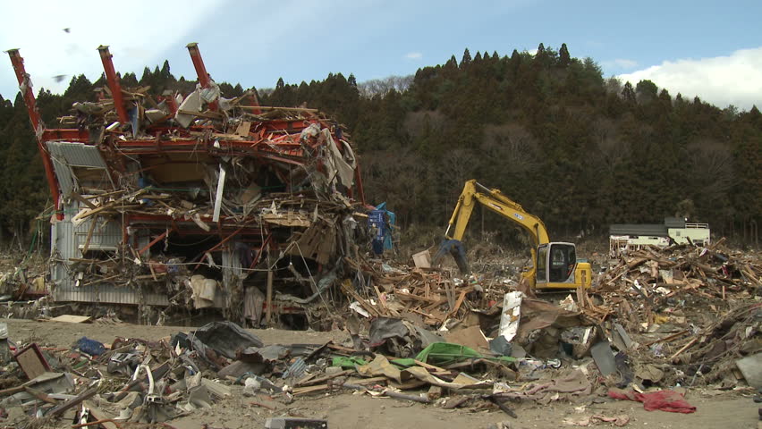 SHIZUGAWA, JAPAN - CIRCA APRIL 2011: Heavy machinery clears debris in tsunami