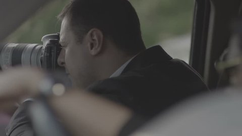 4K Spy, paparazzi or detective in the car, shooting on camera. Shot on RED EPIC Cinema Camera