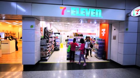 HONG KONG, CHINA - MARCH 31, 2016: 7-Eleven store in Hong Kong mall. Walking between shelves and aisles with goods. 7-Eleven an international chain of convenience stores.		