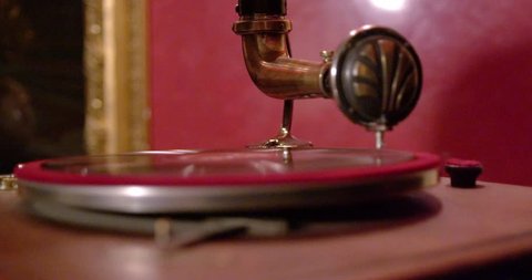 Old gramophone playing vinyl disc closeup.