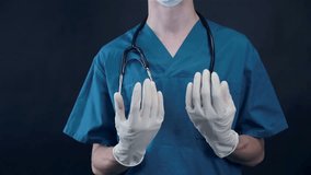 Male doctor removes gloves after hard work.
