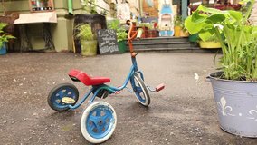 stylish retro  cafe on a city street, small children's  retro bike
