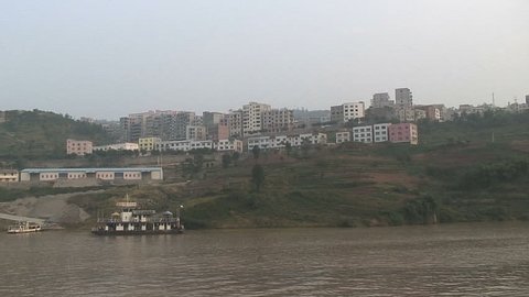Passing by modern buildings on riverbank 