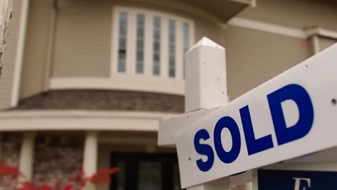 Sold sign in front of a modern home
