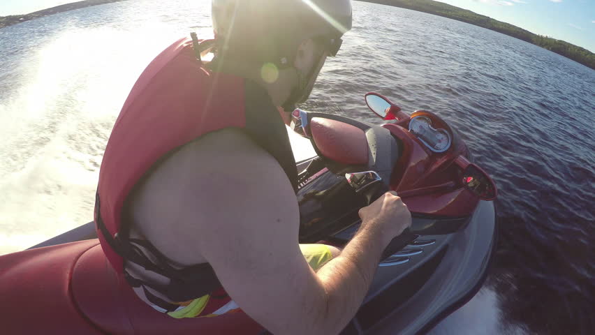 Jet Ski Action Sports rider racing around the lake on his pleasure craft