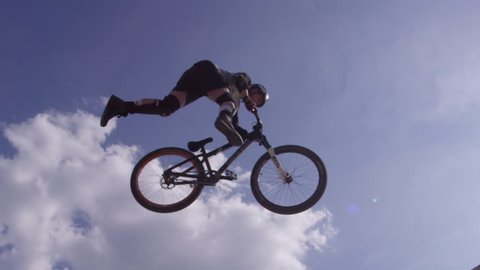 Extreme Sport Mountain Biking Tailwhip in the clouds