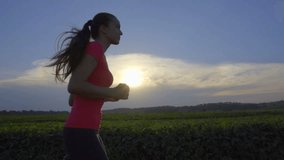 2 in 1 video! The young woman run on the background of the sunset. Wide angle. Slow motion