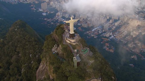 RIO DE JANEIRO, BRAZIL - JUNE 2016: High angle Aerial View of Christ the Redeemer Statue with clouds in Rio de Janeiro, Brazil. View of Christ with people visiting Corcovado Hill.