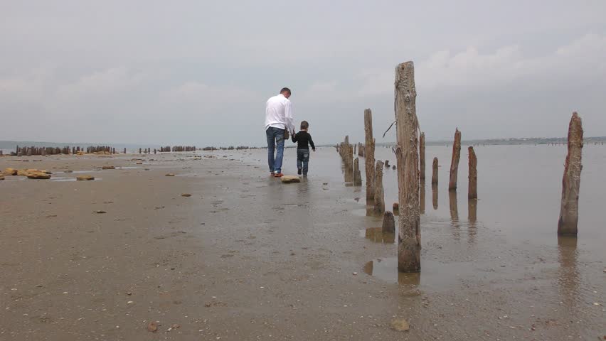 abandoned salt farm on the salt Lake. Father and son playing