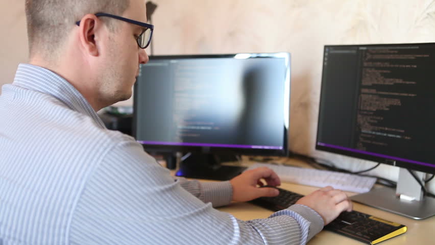 Freelance programmer working on software code sitting at the computer. | Shutterstock HD Video #17835967