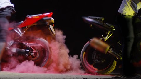 Super sport motorcycle doing a tire burnout with colorful sand, holi. Shot on RED EPIC Cinema Camera in slow motion.