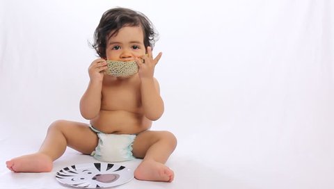 baby eating melon - white background