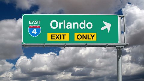 Orlando Interstate Exit Sign with Time Lapse Clouds