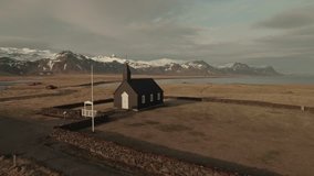 Drone footage of old church and snowcapped mountains at Budir