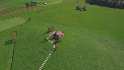 4K Lovely farm aerial shot / Farm - barn surrounded by fields and nature