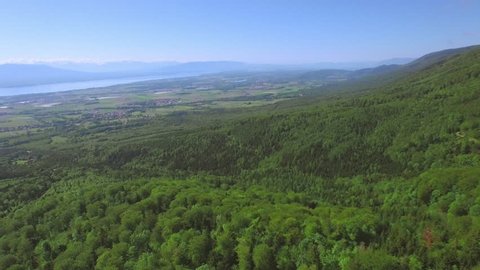 4K European forest aerial shot / Discovering Lake Geneva in the background