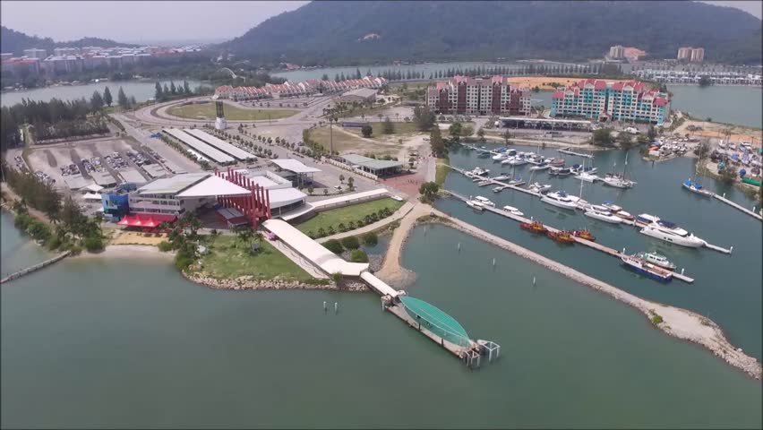 Aerial footage of unidentified boats docking at the harbor located in northern Malaysia. 