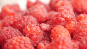 Lot of European raspberry red healthy fruit on pile slow tilt 2160p 30fps UltraHD footage - Rubus idaeus natural vitamin and  antioxidant fruit culture 4K 3840X2160 UHD tilting video