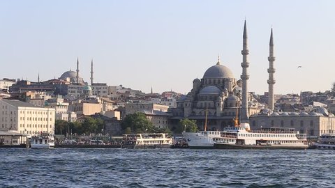 ISTANBUL, TURKEY - JULY 31, 2015 : Eminonu Harbor, Beyoglu district historic architecture and Muslim Mosque medieval landmark over the Golden Horn bay in Istanbul, Turkey