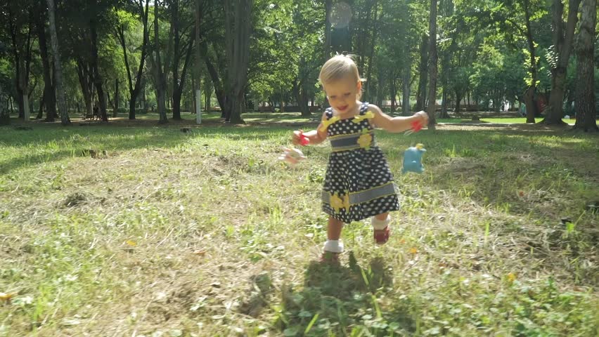 Happy Little Child, Baby Girl Laughing and Playing in the Nature Walk.