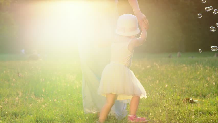 Mother and daughter playing in park