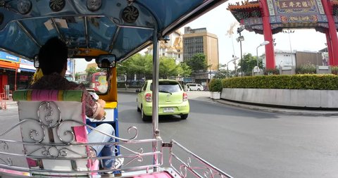 BANGKOK, THAILAND - NOVEMBER 14, 2015: Traveling with traditional Tuk Tuk. Auto rickshaws are the fastest ways of getting around congested Bangkok streets.