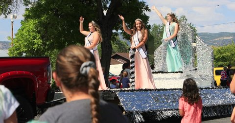MORONI, UTAH - 4 JUL 2016: Royalty Mount Pleasant Utah parade float. Small rural community annual celebration. Family and friends gather to cheer. Fun way to celebrate freedom and pride.